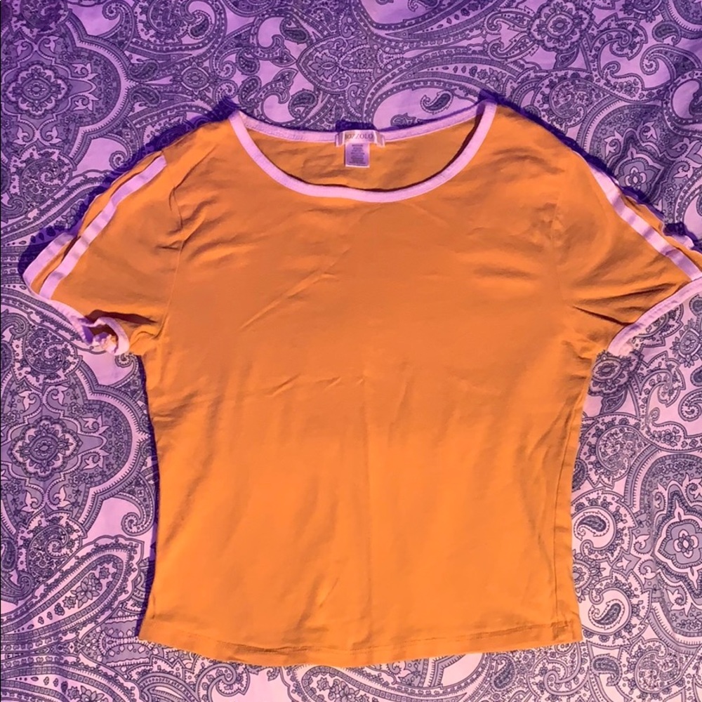 yellow croptop with white designs on the shoulders
